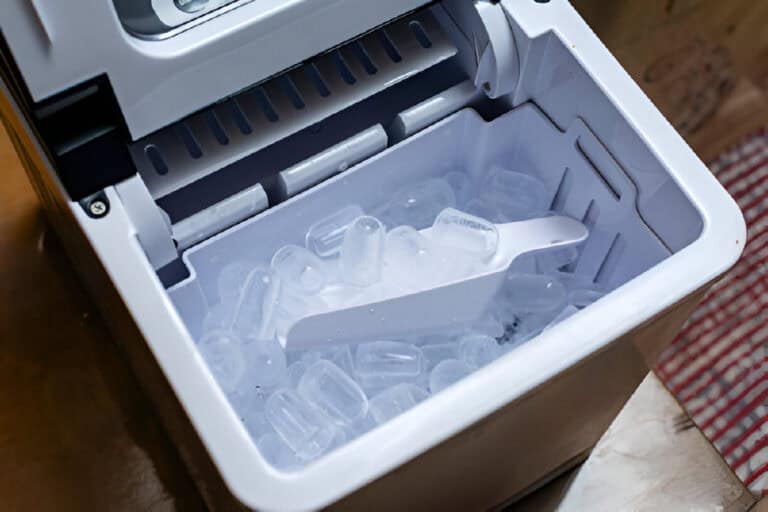portable automatic ice maker with the lid open showing an ice cube tray